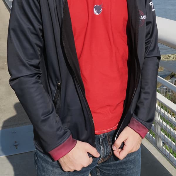 torso of man with red tshirt and an opened black sport jacket