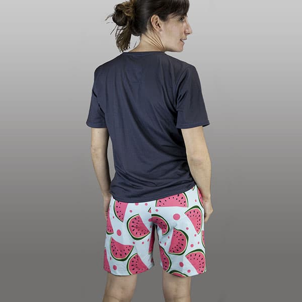 back of woman wearing watermelon shorts and dark grey tshirt