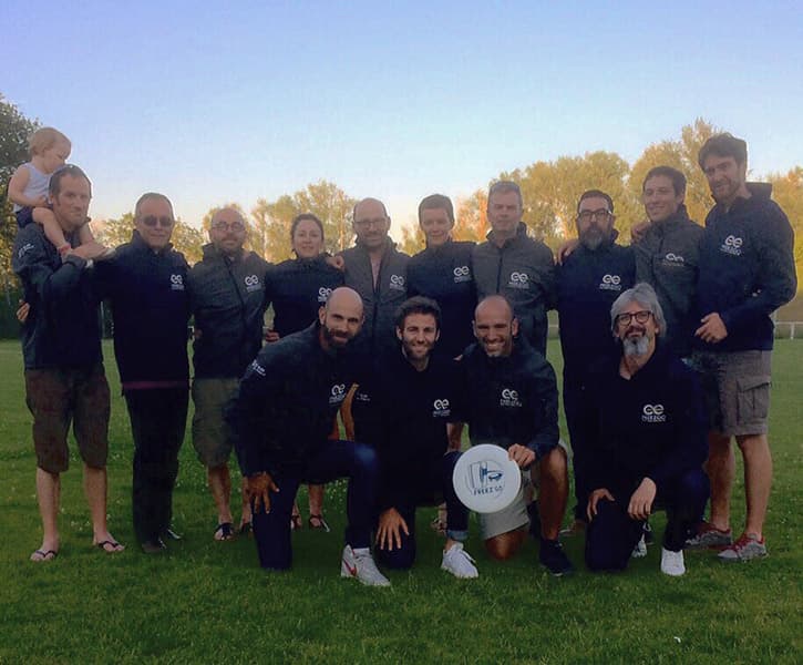 sport team posing on grass field wearing softshells